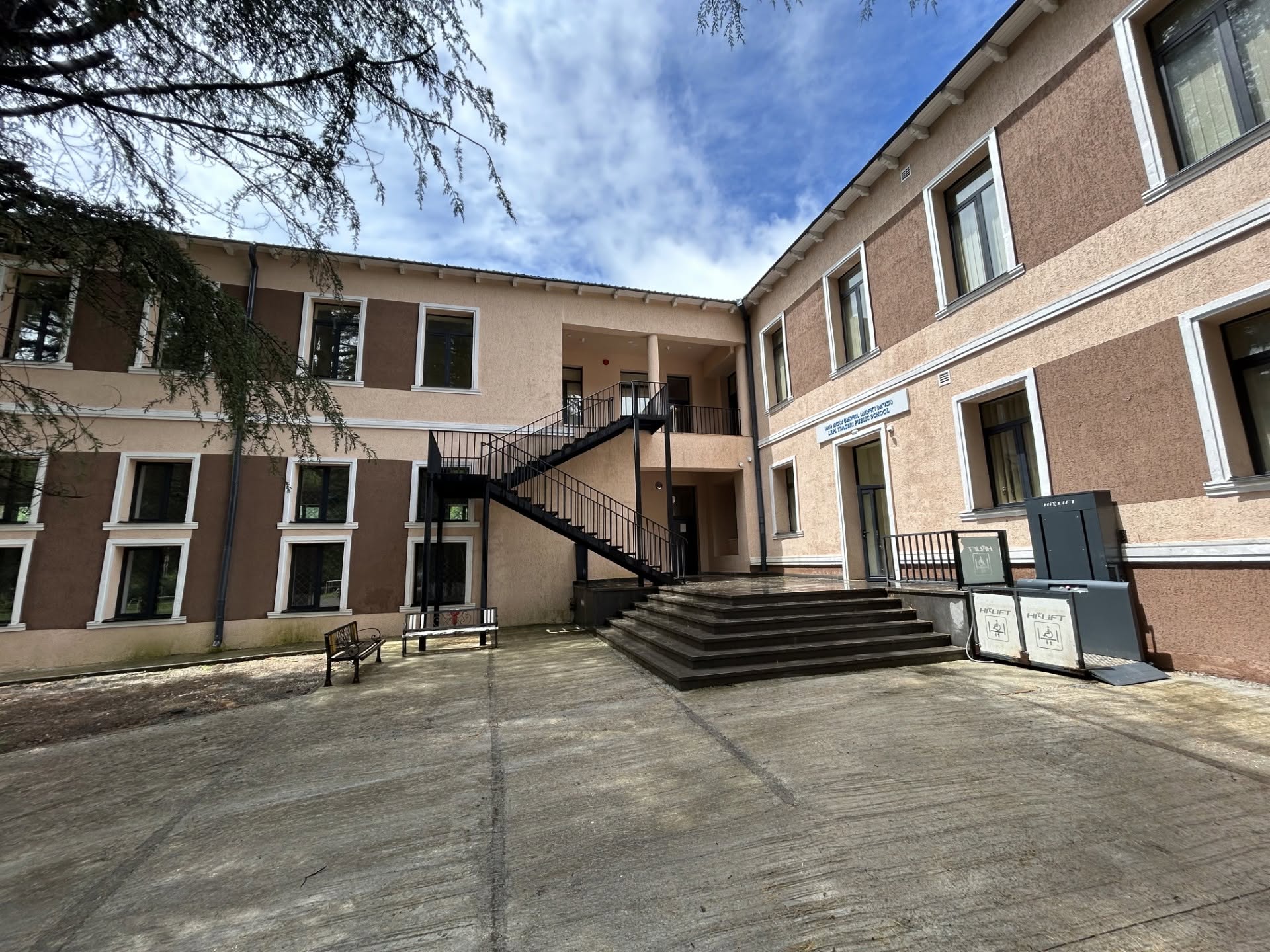 School courtyard with staircase and benches